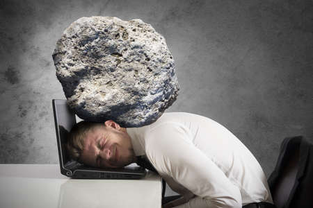 stressed people: Concept of stress with businessman with a rock on the head Stock Photo