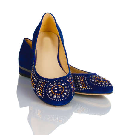 Elegant blue flat shoes for women in stones isolated on\
white