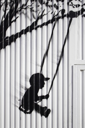 16475843-child-on-swing-drawn-on-door-silhouette-and-urban-art.jpg