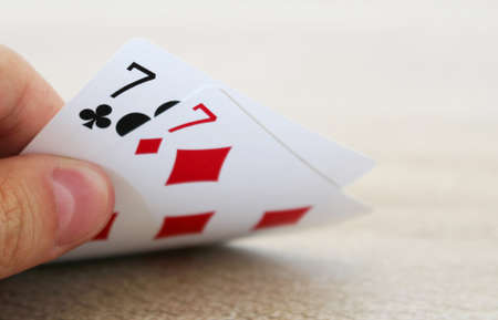 poker: Poker game with hand of two lucky sevens Stock Photo