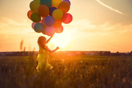 balloon: Little girl with balloons in the field