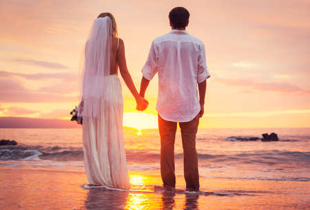 wedding: Bride and Groom, Enjoying Amazing Sunset on a Beautiful Tropical Beach, Romantic Married Couple Stock Photo