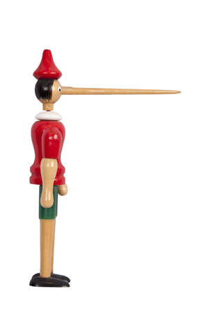 Wooden Pinocchio doll with long nose isolated on white photo