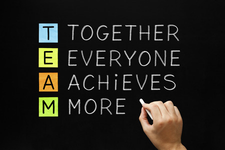Hand writing TEAM - Together Everyone Achieves More with white chalk on blackboard. Stock Photo - 27882385