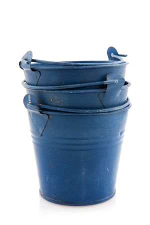 stacked buckets: stacked old blue buckets isolated over white