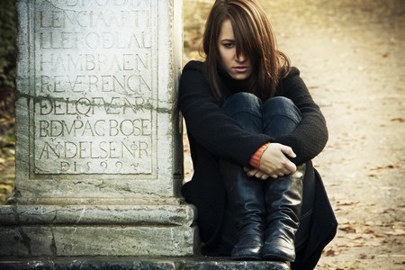 Sad woman sitting in a grave. Stok Foto�raf - 4023160