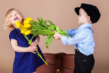 http://us.123rf.com/450wm/kazakphoto/kazakphoto1302/kazakphoto130200241/18061359-funny-kids-happy-little-boy-giving-a-cute-girl-bouquet-of-yellow-spring-flowers-series-in-studio.jpg