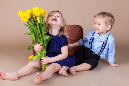 http://us.123rf.com/450wm/kazakphoto/kazakphoto1302/kazakphoto130200243/18061345-funny-kids-happy-little-boy-giving-a-cute-girl-bouquet-of-yellow-spring-flowers-series-in-studio.jpg