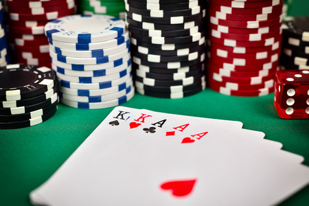 poker: full house and poker chips on green table Stock Photo