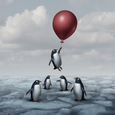 balloon: Advantage business concept and leadership innovation metaphor as a group of penguins standing on ice with one individual rising up with a balloon as a motivation and new idea symbol.