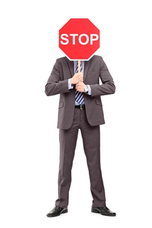18751281-full-length-portrait-of-a-man-in-suit-covering-his-face-with-a-stop-sign-isolated-on-white-backgroun.jpg