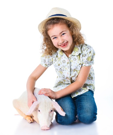 Pequeña granjera. Linda chica con su cerdo. Foto de archivo. Pequeña granjera. Linda chica con su cerdo. Foto de archivo.
