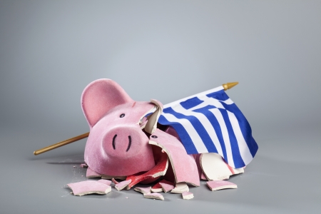 Broken piggy bank with Greek flag - symbolic image for the dramatic financial crisis of the country.