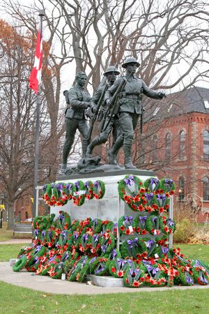 11868342-rembrance-day-wreaths-placed-at-the-base-of-a-war-memorial-to-the-veterans-of-the-first-and-second-w.jpg