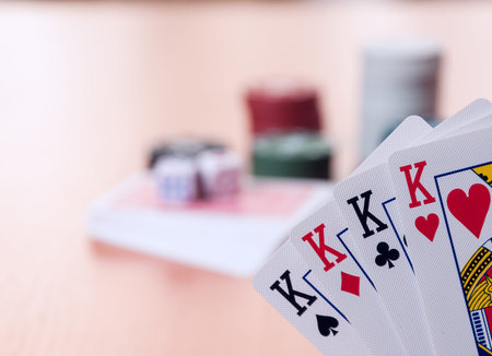poker: Poker chips and generic playing cards. Courts for poker chips and dice on wooden table