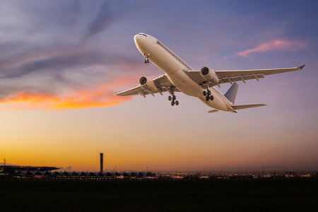 airplane take off: Commercial airplane take off at sunset Stock Photo