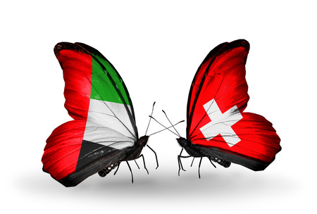 Two butterflies with flags on wings as symbol of relations UAE and Switzerland Stock Photo Two butterflies with flags on wings as symbol of relations UAE and Switzerland Stock Photo - 23772247