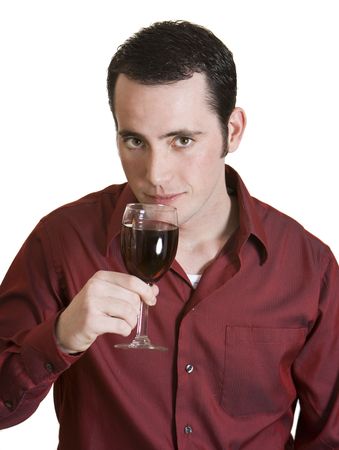Young dark-haired man with red shirt and glass of red wine isolated on white background. Stock Photo
