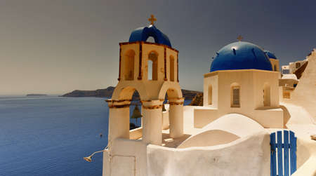 A sunset view of a couple of the famous blue domed churches from Oia on the greek isle of Santorini.