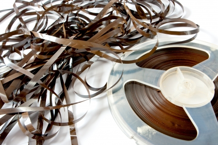 14409364-old-magnetic-tape-reel-loose-tape-on-white-background.jpg