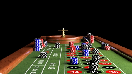 poker: Roulette wheel and table with poker chips.Black background