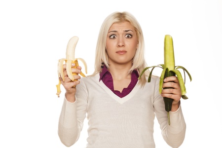 girl with a smile on his face offered a banana and cucumber Stock Photo - 17537596