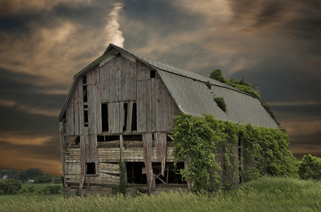 Dilapidated old barn with sunset sky