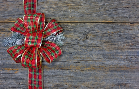 red plaid christmas bow on rustic barn wood stock photo picture and plaid christmas bow