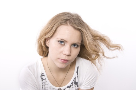Blonde girl with hair blown by wind