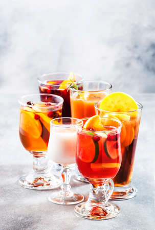 Selection Of Autumn Or Winter Alcoholic Hot Drinks And Cocktails - Mulled Wine, Glogg, Grog, Eggnog, Warm Ginger Ale, Hot Buttered Rum, Punch, Mulled Apple Cider On Gray Background, Copy Space