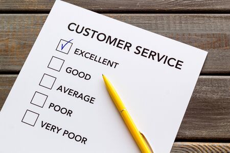 Customer service form close up on dark wooden background top view. Stock Photo