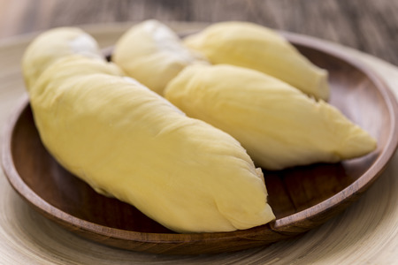 Durian: Close up of yellow Durian in wooden plate on wood table