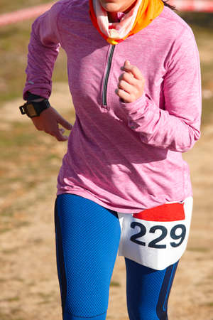 female athletic runner on a race outdoor circuit vertical stock