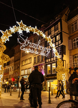 stock photo strasbourg france nov 28 2015 police officers surveilling the entrance gate with neon christmas decorations of the christmas market in - Police Officer Christmas Decorations stock photo strasbourg france nov 28 2015 police officers surveilling the entrance gate with neon christmas decorations of the christmas market in - Police Officer Christmas Decorations