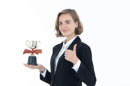 Portrait of successful business woman hoding trophy on white isolated background.