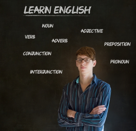 Learn English confident handsome man teacher chalk blackboard background Stock Photo