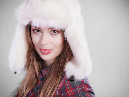 young woman wearing fluffy cap teenage make silly face cold