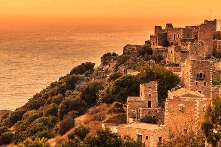 Greece vatheia village at sunset. old abandoned tower houses in vathia mani peninsula in evening time. laconia peloponnese, europe.