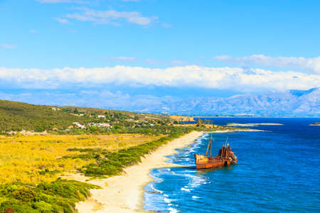 Greek coastline with the famous rusty shipwreck dimitrios in glyfada beach near gytheio, gythio laconia peloponnese greece. view from distance.