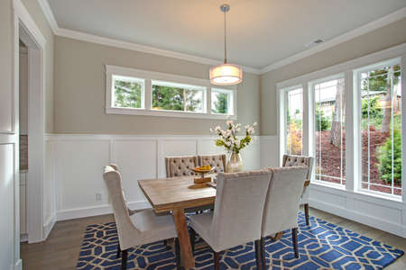 Elegant Transitional Dining Room With Board And Batten Walls Wood Table Surrounded By Grey Elegant Transitional Dining Room With Board And Batten Walls Wood Table Surrounded By Grey