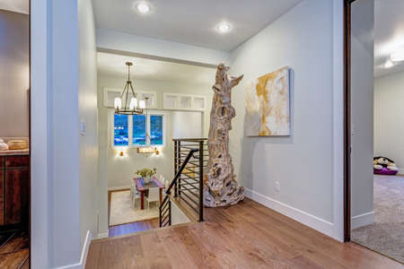 Second Floor Landing With White Walls Maple Hardwood And A Driftwood Statue Next To Second Floor Landing With White Walls Maple Hardwood And A Driftwood Statue Next To