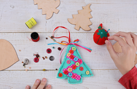 child making felt christmas tree decoration ornament close up kids art art projects - Handmade Felt Christmas Decorations child making felt christmas tree decoration ornament close up kids art art projects - Handmade Felt Christmas Decorations