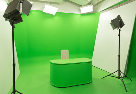 modern tv studio green screen chroma key background with camera