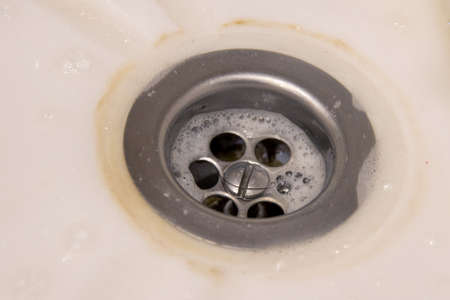 Metal Sink In A White Bathtub, Sink. Dirty Drain. The Concept Of Homework, Disinfection.