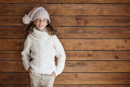 かわいい 9 歳の女の子ニット秋や木製の背景にポーズ冬の服を着る の写真素材 画像素材 Image