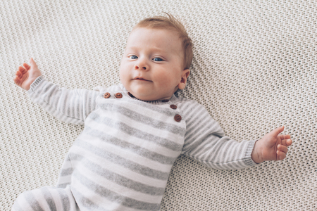 Portrait Of A Cute 2 Month Old Baby Lying Down On A Crochet Blanket