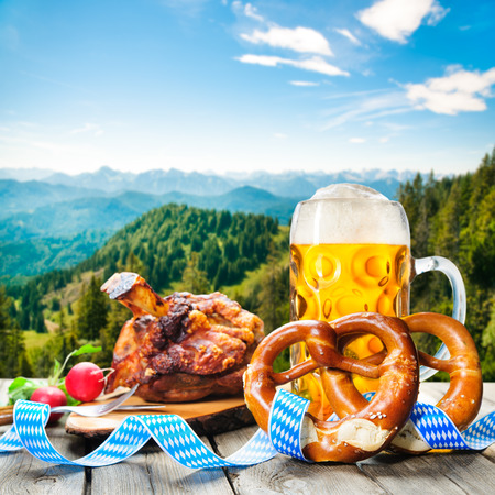 grilled pork: Roasted pork knuckle with pretzels and beer. Oktoberfest german festival background
