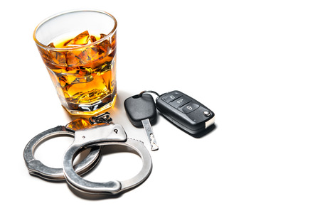 Whiskey with car keys and handcuffs concept for drinking and driving