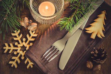 stock photo vintage or rustic christmas table setting with candle and wooden decorations cutlery on linen napkin on rustic wooden background country - Rustic Country Christmas Table Decorations stock photo vintage or rustic christmas table setting with candle and wooden decorations cutlery on linen napkin on rustic wooden background country - Rustic Country Christmas Table Decorations