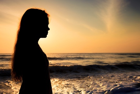 sad lonely: Silhouette of a sad child on the beach